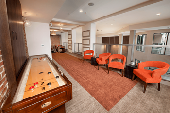 a game room with a foosball table and chairs